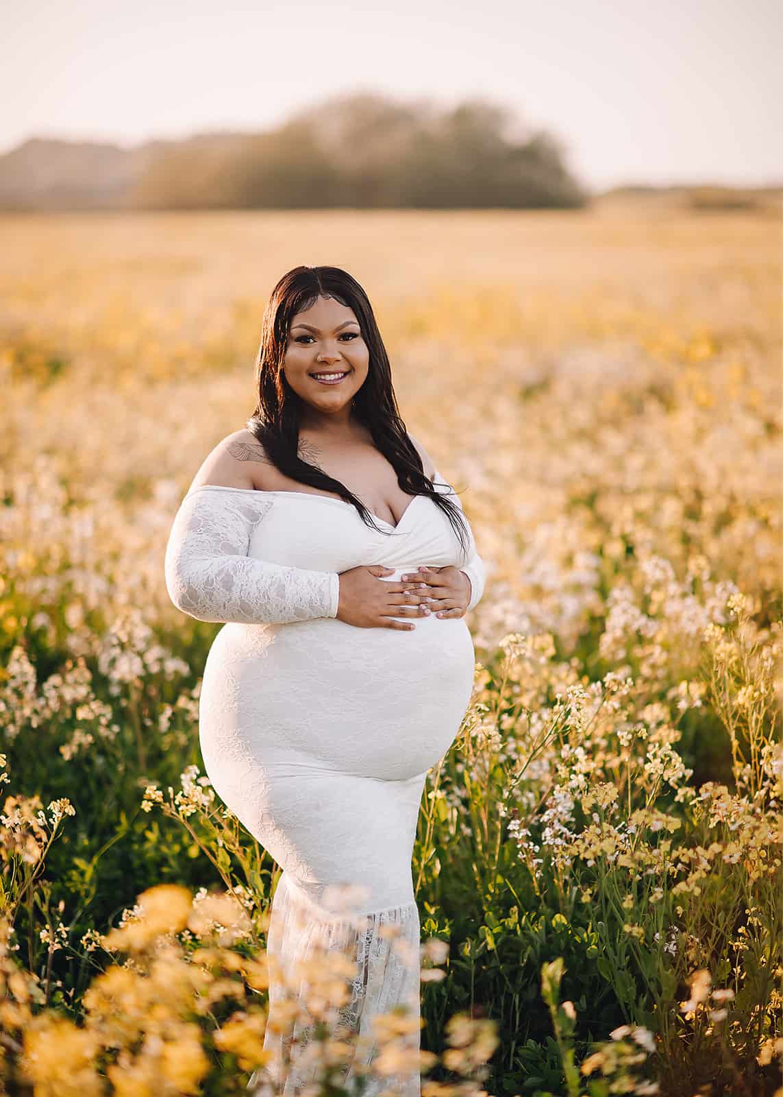 mom to be in white maternity gown standing in a golden field Cloud Massage Company