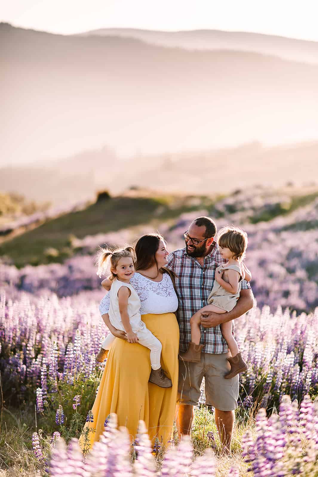 Mom to be with husband and kids in a lavender field