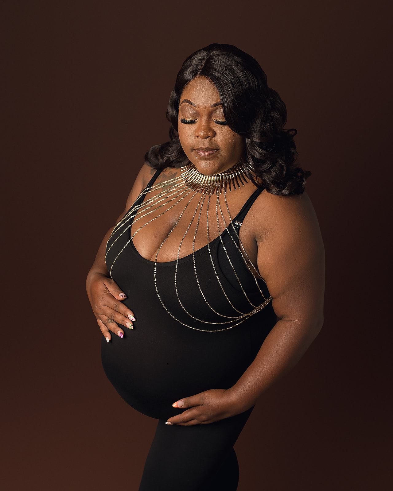 pregnant woman in black dress with jeweled details