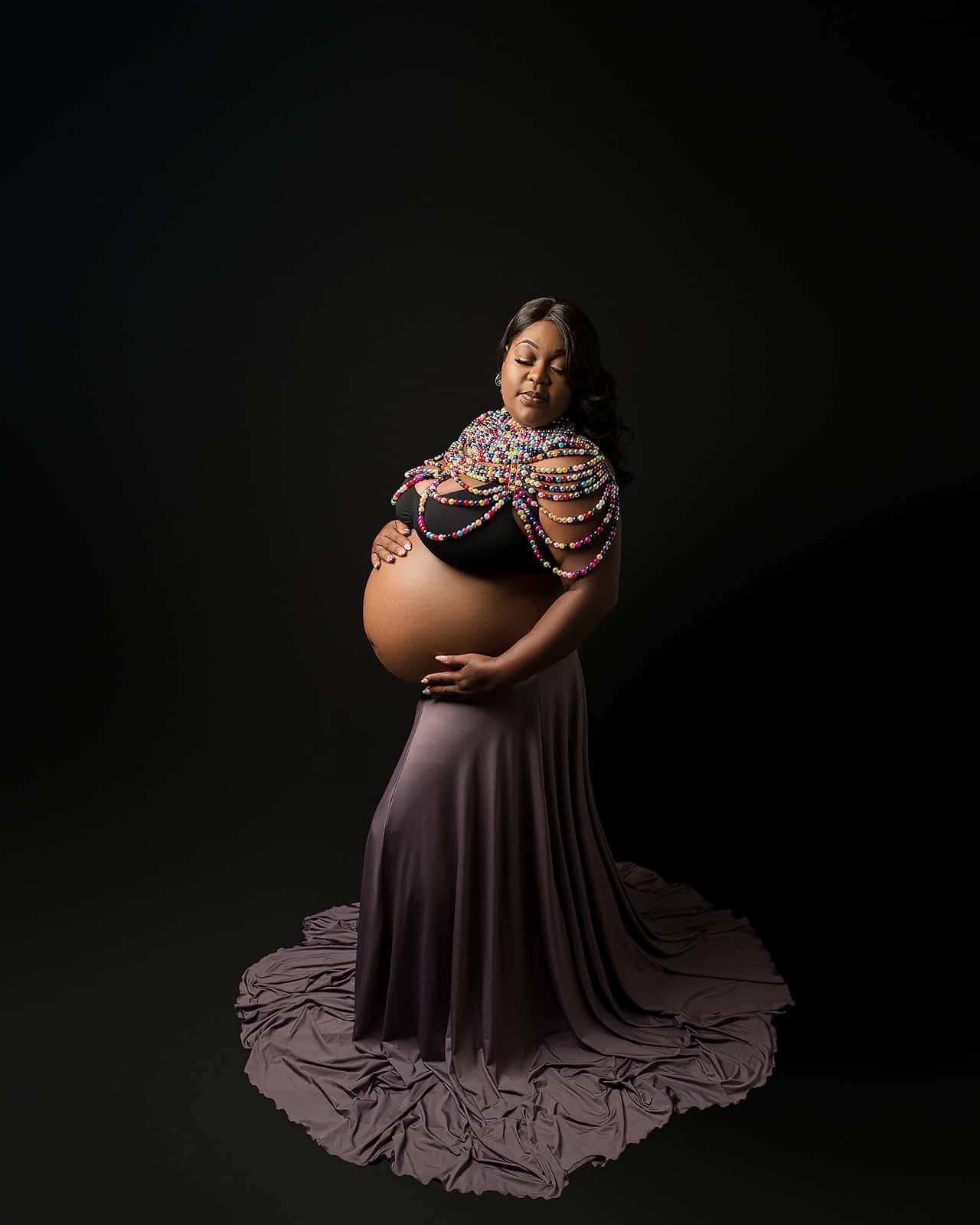 mom to be in bra and long skirt, decorated with a beaded shawl Wellness ware